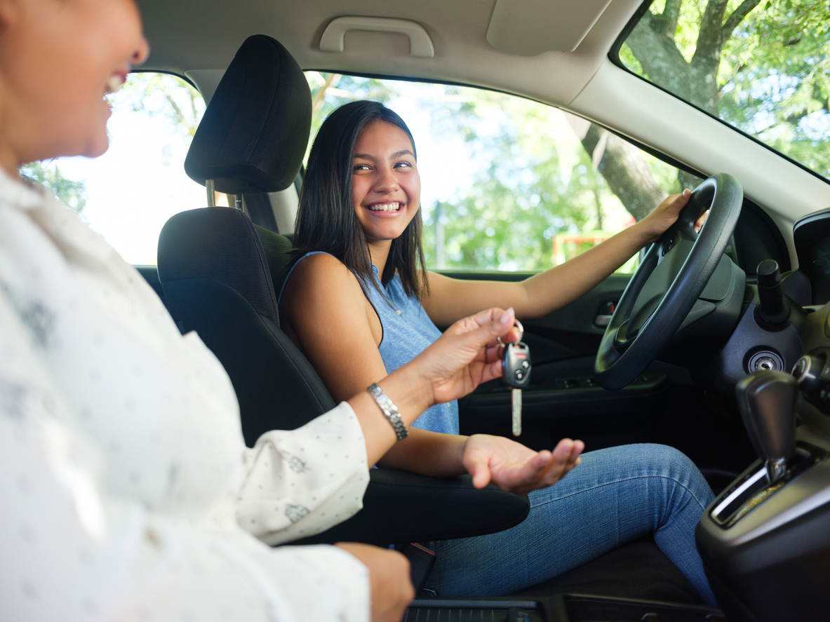 A girl behind the wheel with instructor